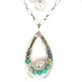 Moonstone drop gemstone held inside a sterling silver channel drop necklace lined with moss agate, amazonite, and terra verde jasper gemstones on a delicate sterling silver chain