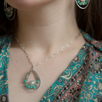 Moonstone drop gemstone held inside a sterling silver channel drop necklace lined with moss agate, amazonite, and terra verde jasper gemstones on a delicate sterling silver chain
