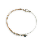 Half sterling silver, half bronze hammered arrow shaped bracelet embellished with an iolite sphere and fancy jasper gemstones