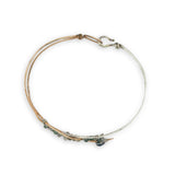 Half sterling silver, half bronze hammered arrow shaped bracelet embellished with an iolite sphere and fancy jasper gemstones