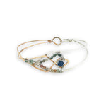 Half sterling silver, half bronze hammered arrow shaped bracelet embellished with an iolite sphere and fancy jasper gemstones