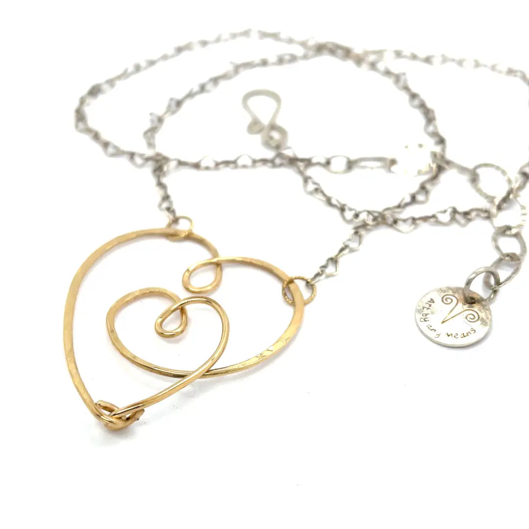 handmade hammered gold filled heart with one mini heart built in pendant on a sterling silver delicate heart chain