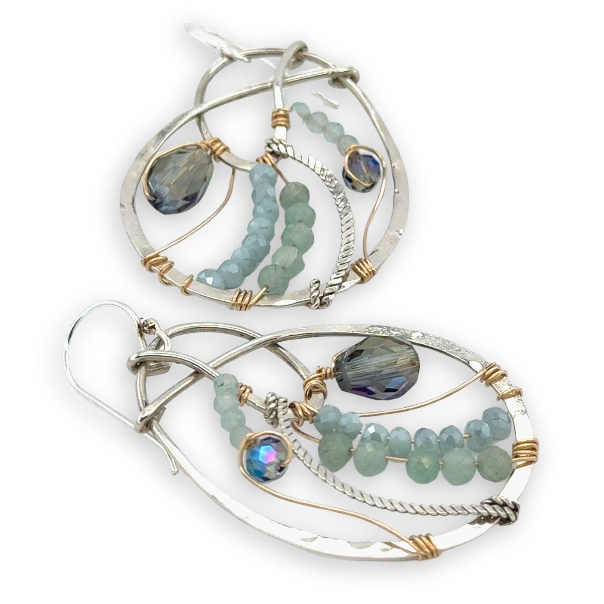 Aquamarine, amazonite, and crystal gemstones line the inside of our sterling silver nautilus shell earrings with gold filled wire