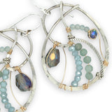 Aquamarine, amazonite, and crystal gemstones line the inside of our sterling silver nautilus shell earrings with gold filled wire