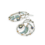 Aquamarine, amazonite, and crystal gemstones line the inside of our sterling silver nautilus shell earrings with gold filled wire