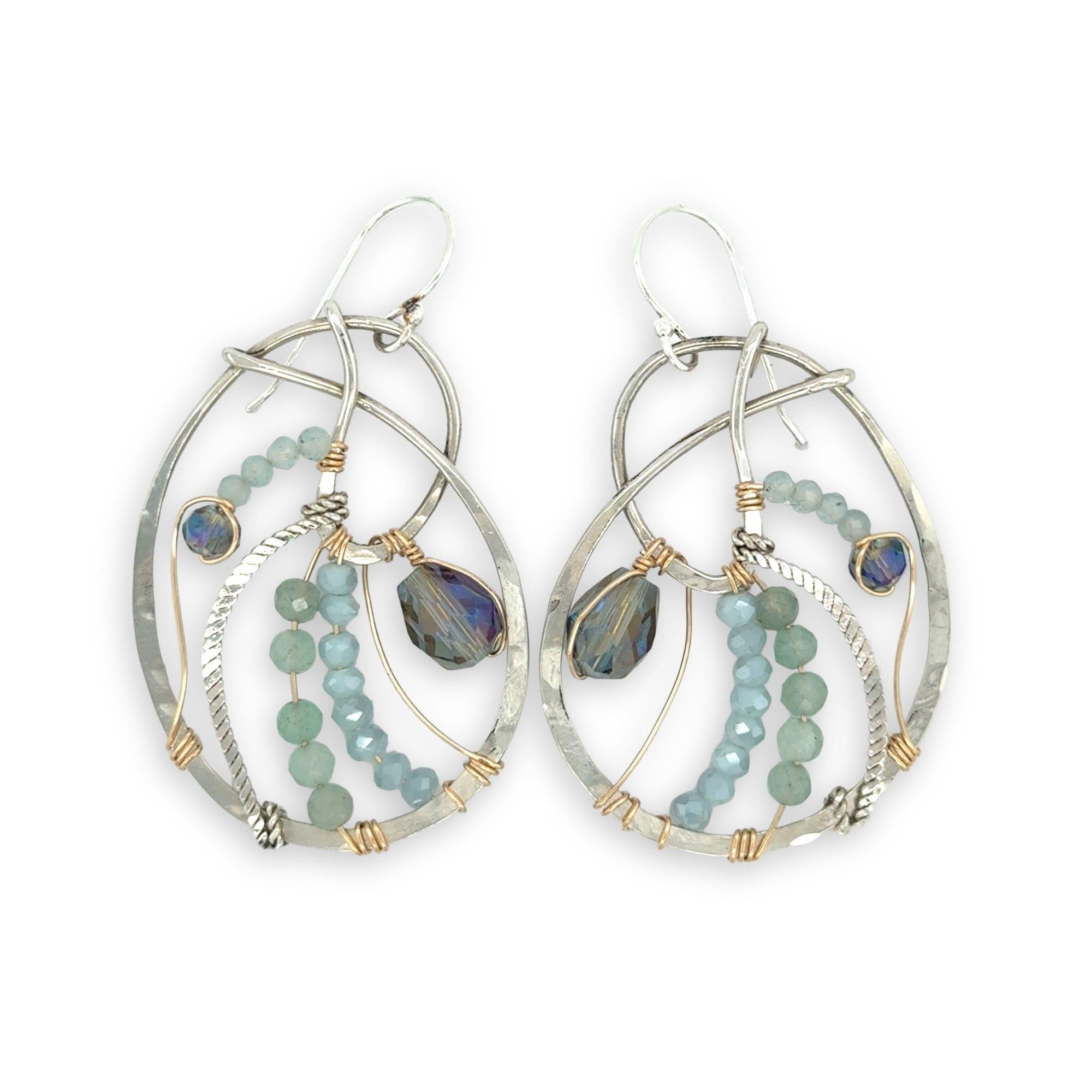 Aquamarine, amazonite, and crystal gemstones line the inside of our sterling silver nautilus shell earrings with gold filled wire