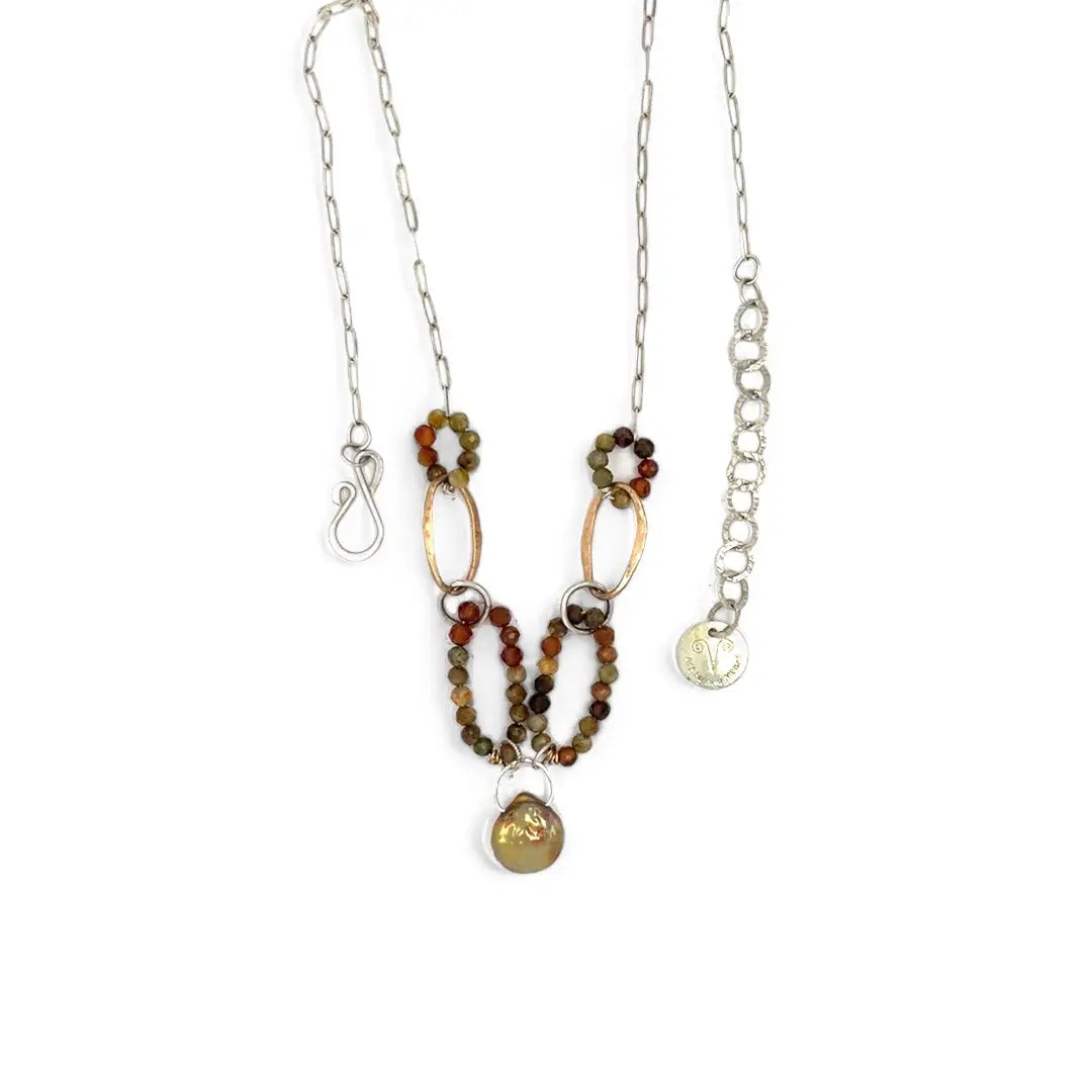 Hammered bronze links interspered with hessonite garnet links necklace on sterling silver chain hold a mauve/pink color fresh water pearl 