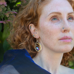 Blue crystal with labradorite accent on  stamped and darkened sterling silver drop earring with a brass hammered swish