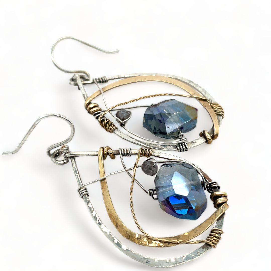 Blue crystal with labradorite accent on  stamped and darkened sterling silver drop earring with a brass hammered swish