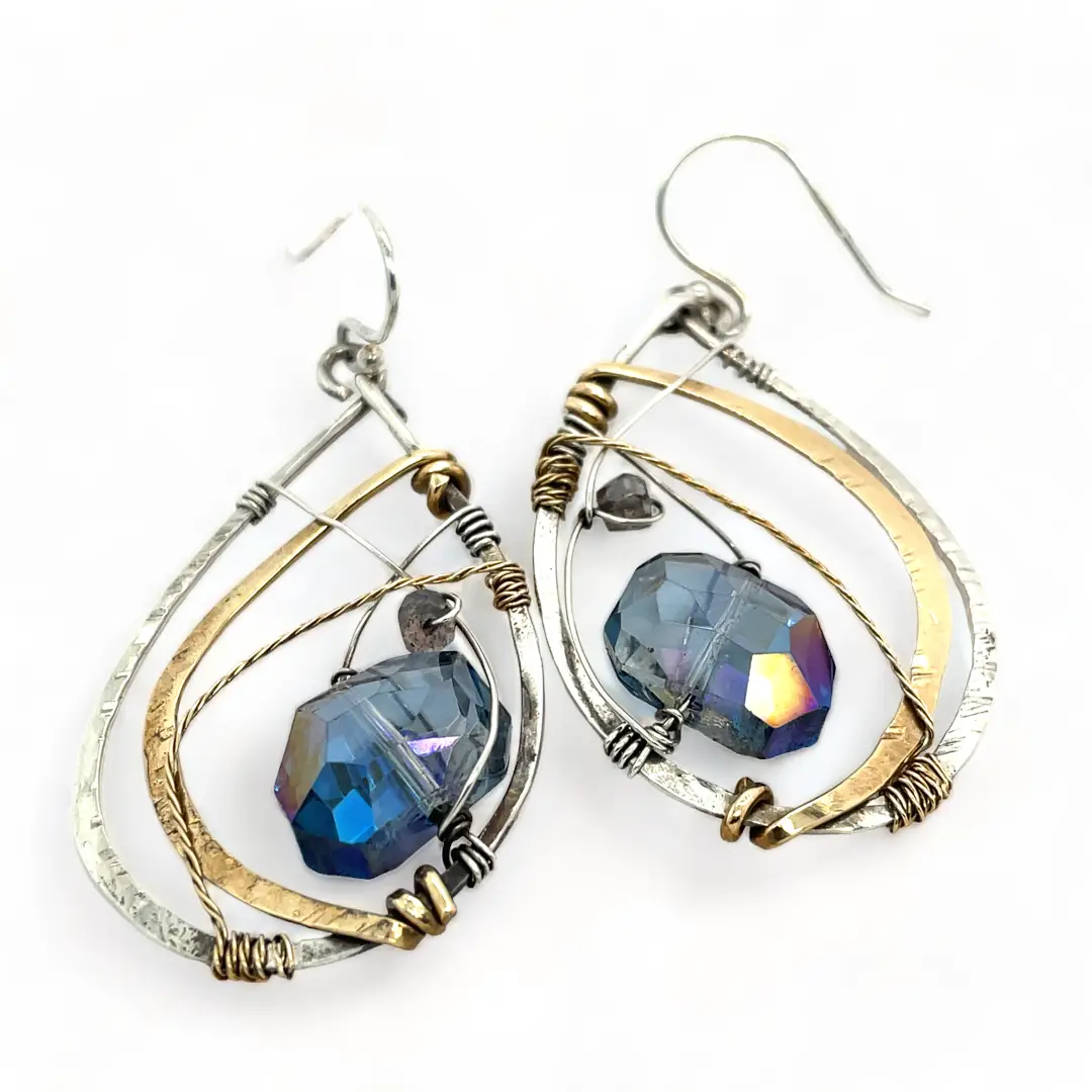 Blue crystal with labradorite accent on  stamped and darkened sterling silver drop earring with a brass hammered swish