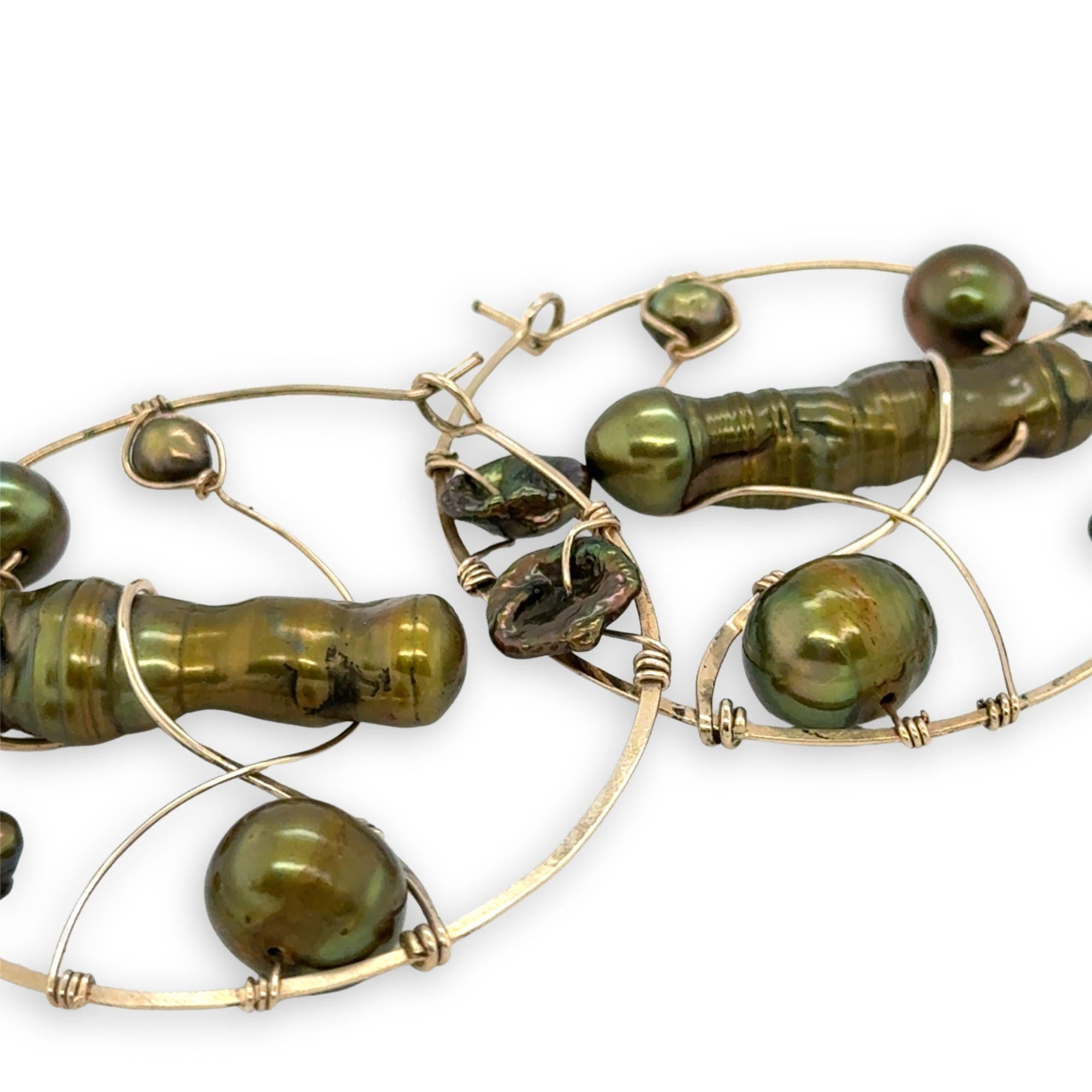 Gold filled hoop earrings embroidered with a variety of different shaped olive green fresh water pearls