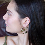 Gold filled hoop earrings embroidered with a variety of different shaped olive green fresh water pearls