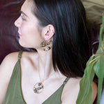 Gold filled hoop earrings embroidered with a variety of different shaped olive green fresh water pearls