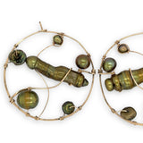 Gold filled hoop earrings embroidered with a variety of different shaped olive green fresh water pearls