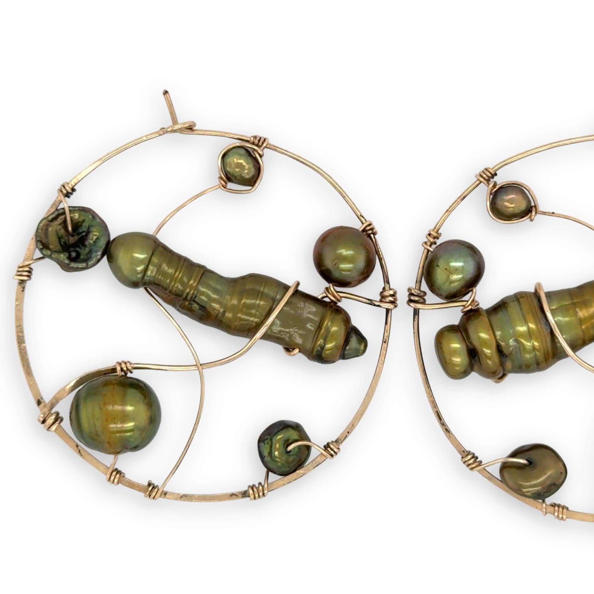 Gold filled hoop earrings embroidered with a variety of different shaped olive green fresh water pearls