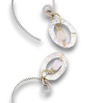 Opal gemstone nuggets dangle within a mini sterling silver hammered oval, hanging from our handmade braided sterling silver earring hoops