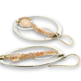 Sterling silver oval earrings stamped with florals, with pink opal mini drop gemstones, sunstone cubes, and cubic zirconia gemstones on gold filled earring hooks