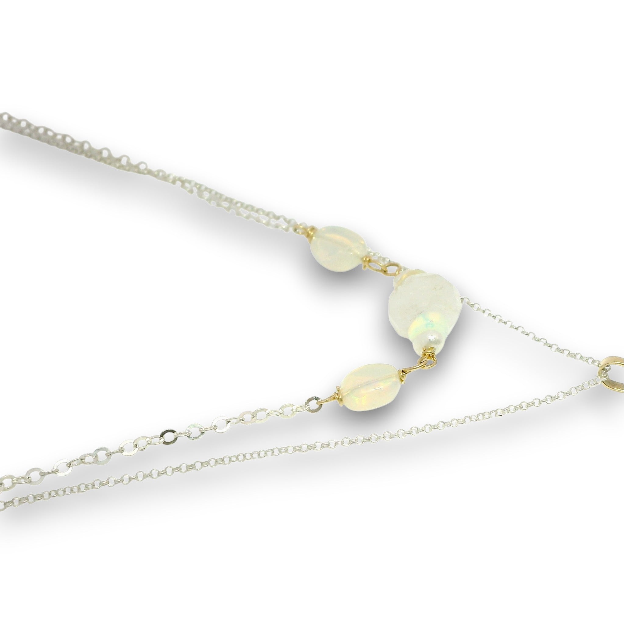 Double necklace with a sterling silver chain, the first layer with opal, moonstone and pearls, and the second layer with a brass teardrop shaped pendant filled with a whiten jade drop, opal, moonstone, and fresh water pearl accents