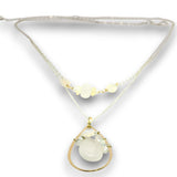Double necklace with a sterling silver chain, the first layer with opal, moonstone and pearls, and the second layer with a brass teardrop shaped pendant filled with a whiten jade drop, opal, moonstone, and fresh water pearl accents