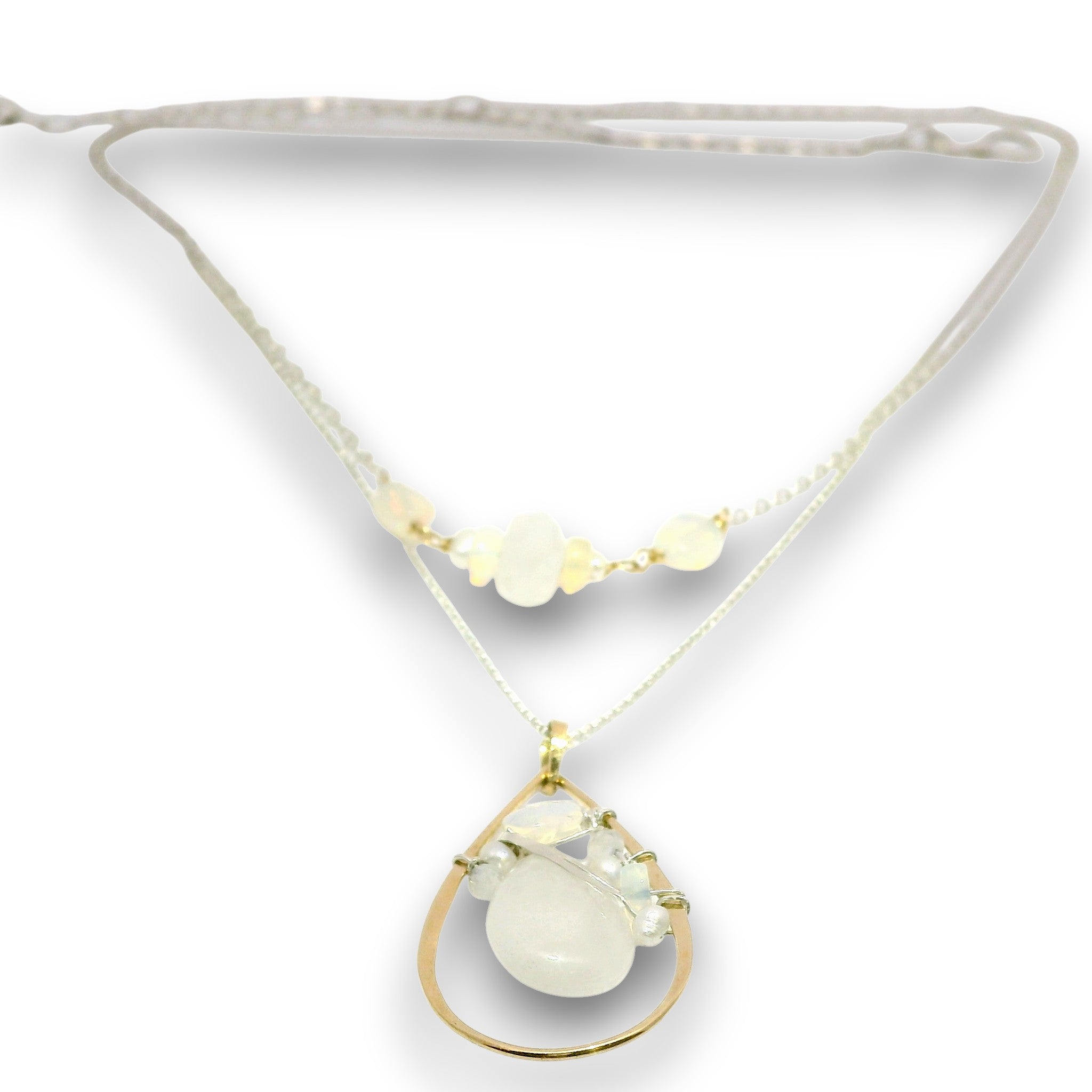 Double necklace with a sterling silver chain, the first layer with opal, moonstone and pearls, and the second layer with a brass teardrop shaped pendant filled with a whiten jade drop, opal, moonstone, and fresh water pearl accents