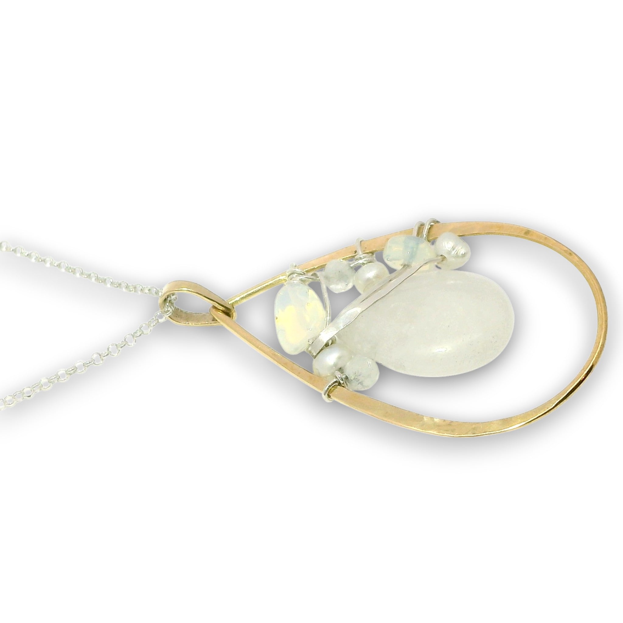 Double necklace with a sterling silver chain, the first layer with opal, moonstone and pearls, and the second layer with a brass teardrop shaped pendant filled with a whiten jade drop, opal, moonstone, and fresh water pearl accents