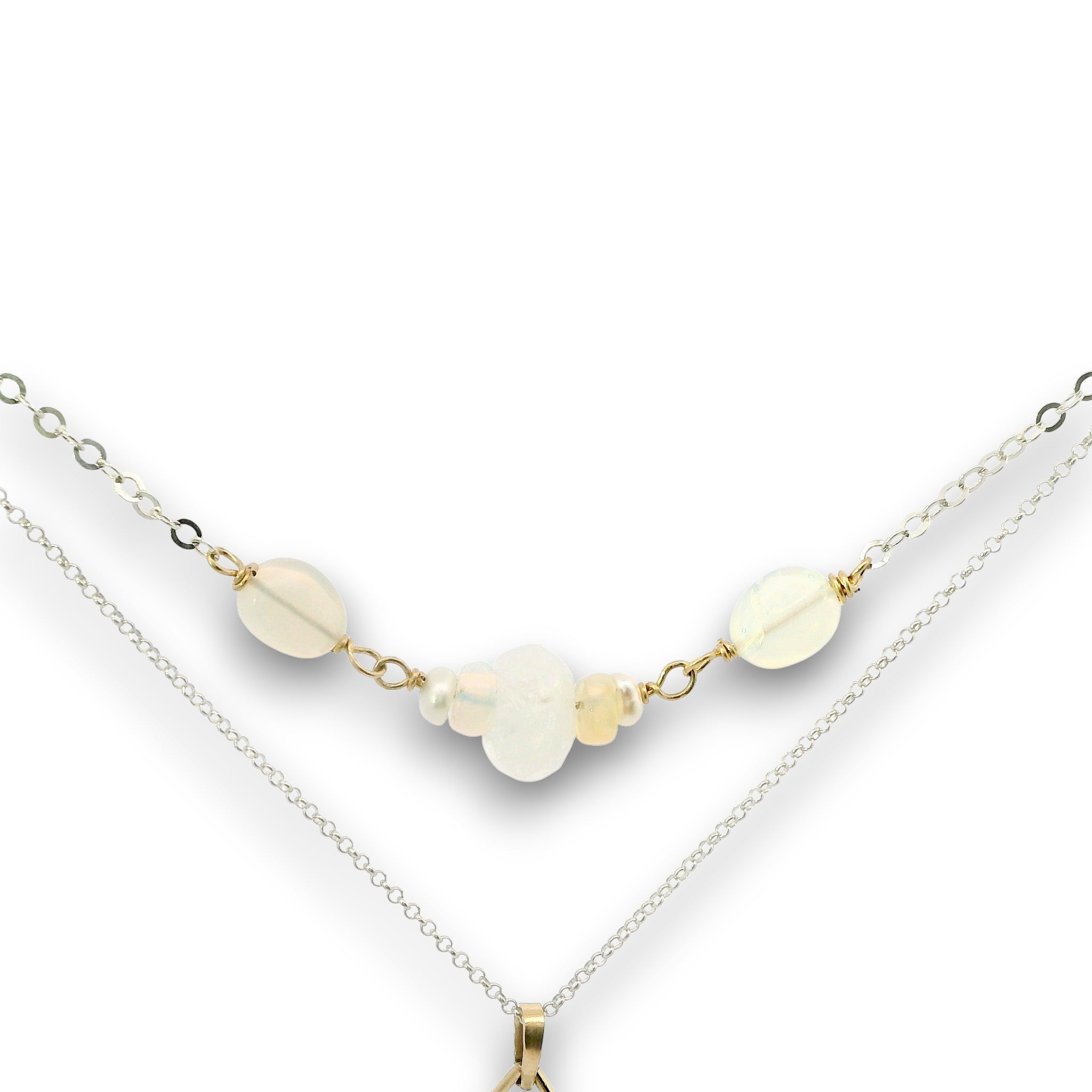 Double necklace with a sterling silver chain, the first layer with opal, moonstone and pearls, and the second layer with a brass teardrop shaped pendant filled with a whiten jade drop, opal, moonstone, and fresh water pearl accents
