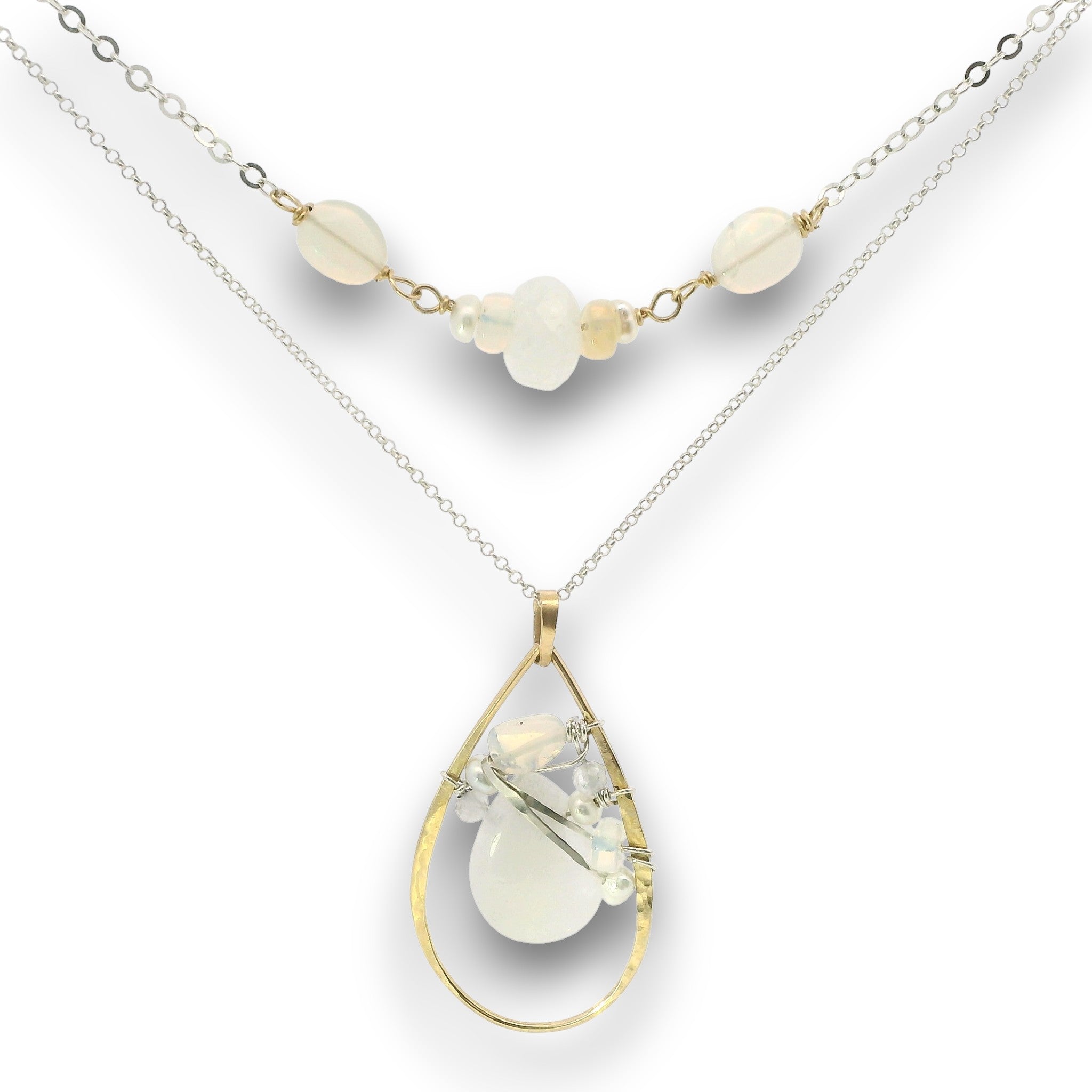 Double necklace with a sterling silver chain, the first layer with opal, moonstone and pearls, and the second layer with a brass teardrop shaped pendant filled with a whiten jade drop, opal, moonstone, and fresh water pearl accents