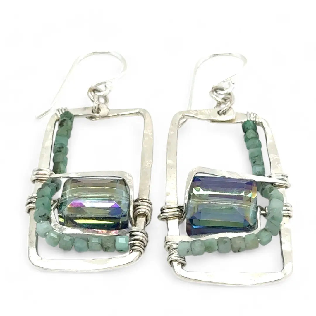 A pair of sterling silver hammered rectangle earrings with square cut blue-green crystals and faceted emerald gemstone cubes.