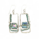 A pair of sterling silver hammered rectangle earrings with square cut blue-green crystals and faceted emerald gemstone cubes.