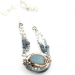 Sterling silver oval pendant with aquamarine nugget wrapped in bronze hammered wire with blue zoisite, and crystal gemstones on a sterling silver chain necklace