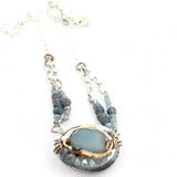 Sterling silver oval pendant with aquamarine nugget wrapped in bronze hammered wire with blue zoisite, and crystal gemstones on a sterling silver chain necklace