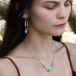 Sterling silver oval pendant with aquamarine nugget wrapped in bronze hammered wire with blue zoisite, and crystal gemstones on a sterling silver chain necklace