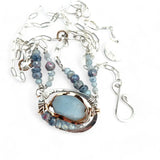 Sterling silver oval pendant with aquamarine nugget wrapped in bronze hammered wire with blue zoisite, and crystal gemstones on a sterling silver chain necklace