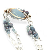 Sterling silver oval pendant with aquamarine nugget wrapped in bronze hammered wire with blue zoisite, and crystal gemstones on a sterling silver chain necklace