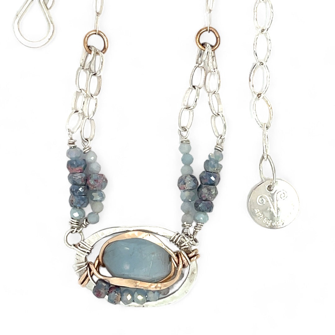 Sterling silver oval pendant with aquamarine nugget wrapped in bronze hammered wire with blue zoisite, and crystal gemstones on a sterling silver chain necklace