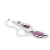 Sterling silver hammered wing shaped earrings with sugilite smooth ovals, lavender cubic zirconia, and amethyst gemstones