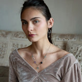 A pair of dark sterling silver mini open hoop earrings with tourmaline and new jade mini drop gemstones, featuring a oxidized sterling silver delicate chain