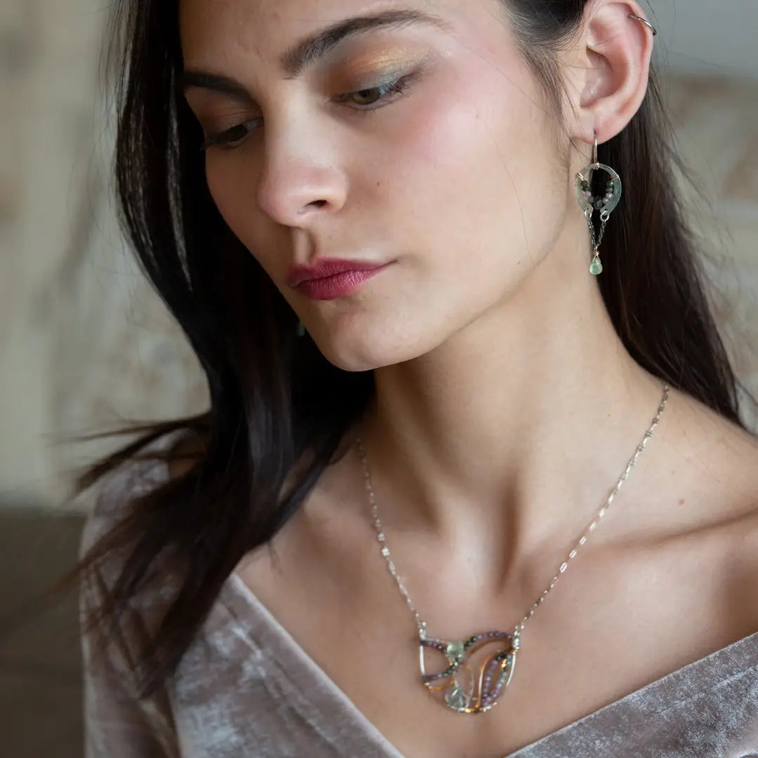 A pair of dark sterling silver mini open hoop earrings with tourmaline and new jade mini drop gemstones, featuring a oxidized sterling silver delicate chain