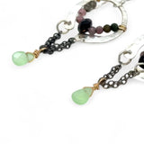 A pair of dark sterling silver mini open hoop earrings with tourmaline and new jade mini drop gemstones, featuring a oxidized sterling silver delicate chain