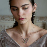 A pair of dark sterling silver mini open hoop earrings with tourmaline and new jade mini drop gemstones, featuring a oxidized sterling silver delicate chain