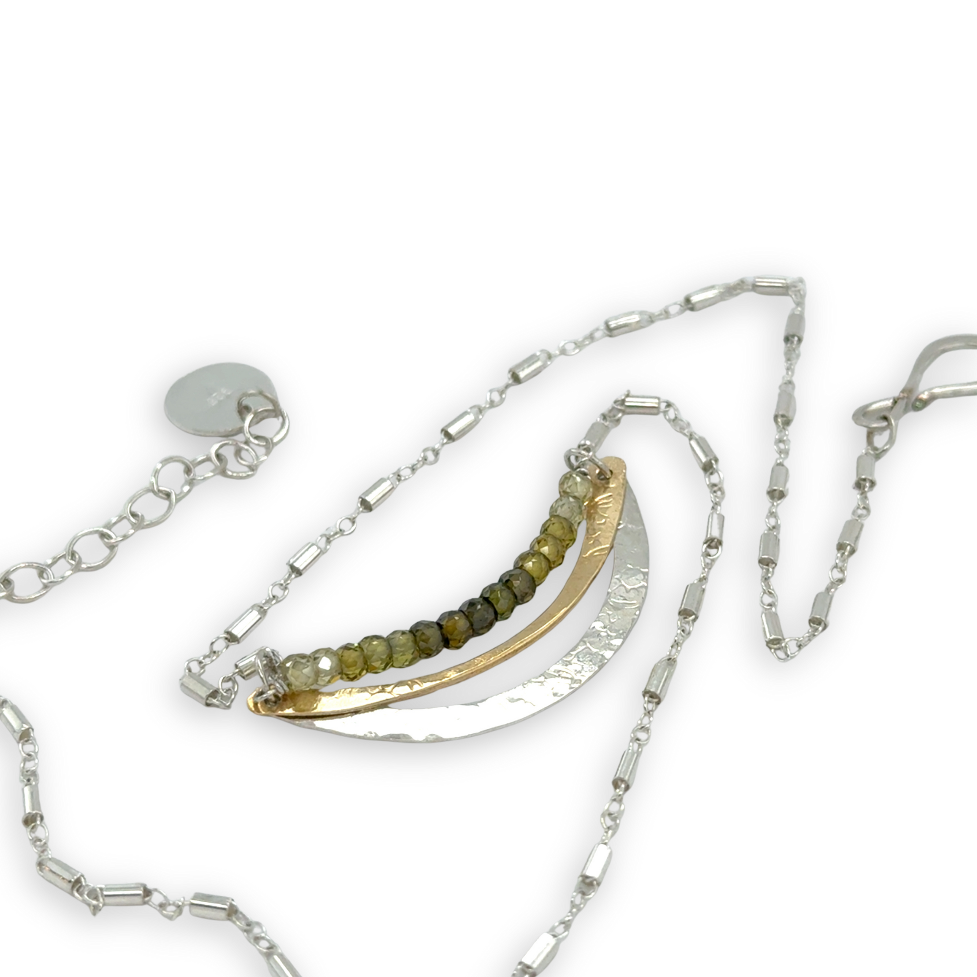 Stamped sterling silver and brass crescent necklace lines with ombre green faceted cubic zirconia gemstones
