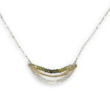 Stamped sterling silver and brass crescent necklace lines with ombre green faceted cubic zirconia gemstones