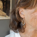 Blue/ purple fresh water pearls and a pyrite drop gemstones sit at the bottom of our handmade hammered sterling silver drop earrings