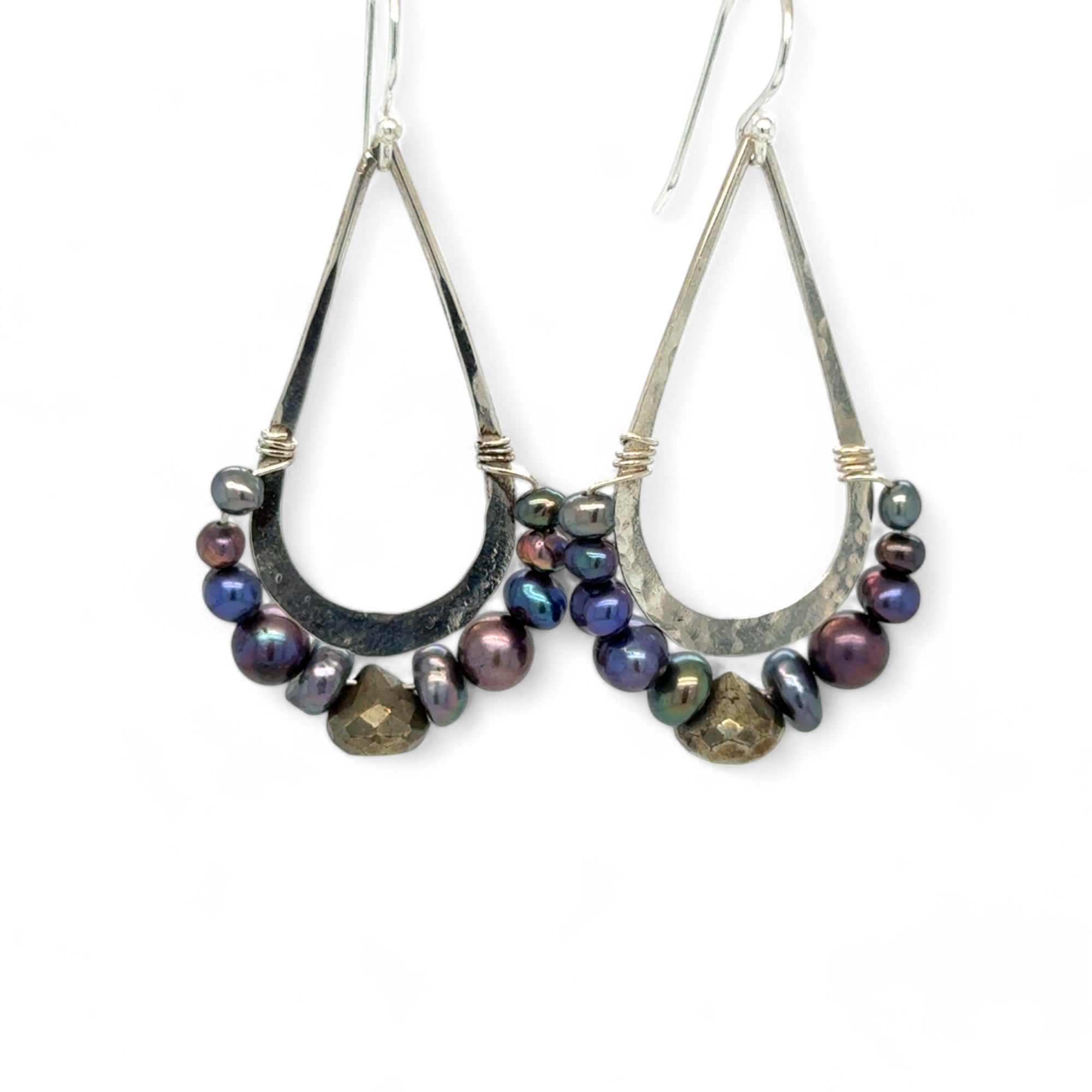 Blue/ purple fresh water pearls and a pyrite drop gemstones sit at the bottom of our handmade hammered sterling silver drop earrings