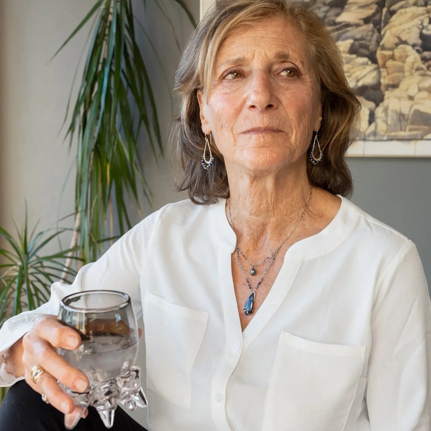 Blue/ purple fresh water pearls and a pyrite drop gemstones sit at the bottom of our handmade hammered sterling silver drop earrings