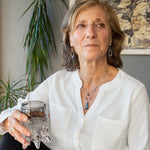 Blue/ purple fresh water pearls and a pyrite drop gemstones sit at the bottom of our handmade hammered sterling silver drop earrings