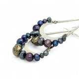 Blue/ purple fresh water pearls and a pyrite drop gemstones sit at the bottom of our handmade hammered sterling silver drop earrings