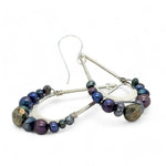 Blue/ purple fresh water pearls and a pyrite drop gemstones sit at the bottom of our handmade hammered sterling silver drop earrings