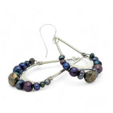Blue/ purple fresh water pearls and a pyrite drop gemstones sit at the bottom of our handmade hammered sterling silver drop earrings