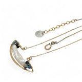 A gold-filled chain necklace with a boat-shaped brass pendant featuring a freshwater pearl stick and aquamarine gemstones at the bow and stern.